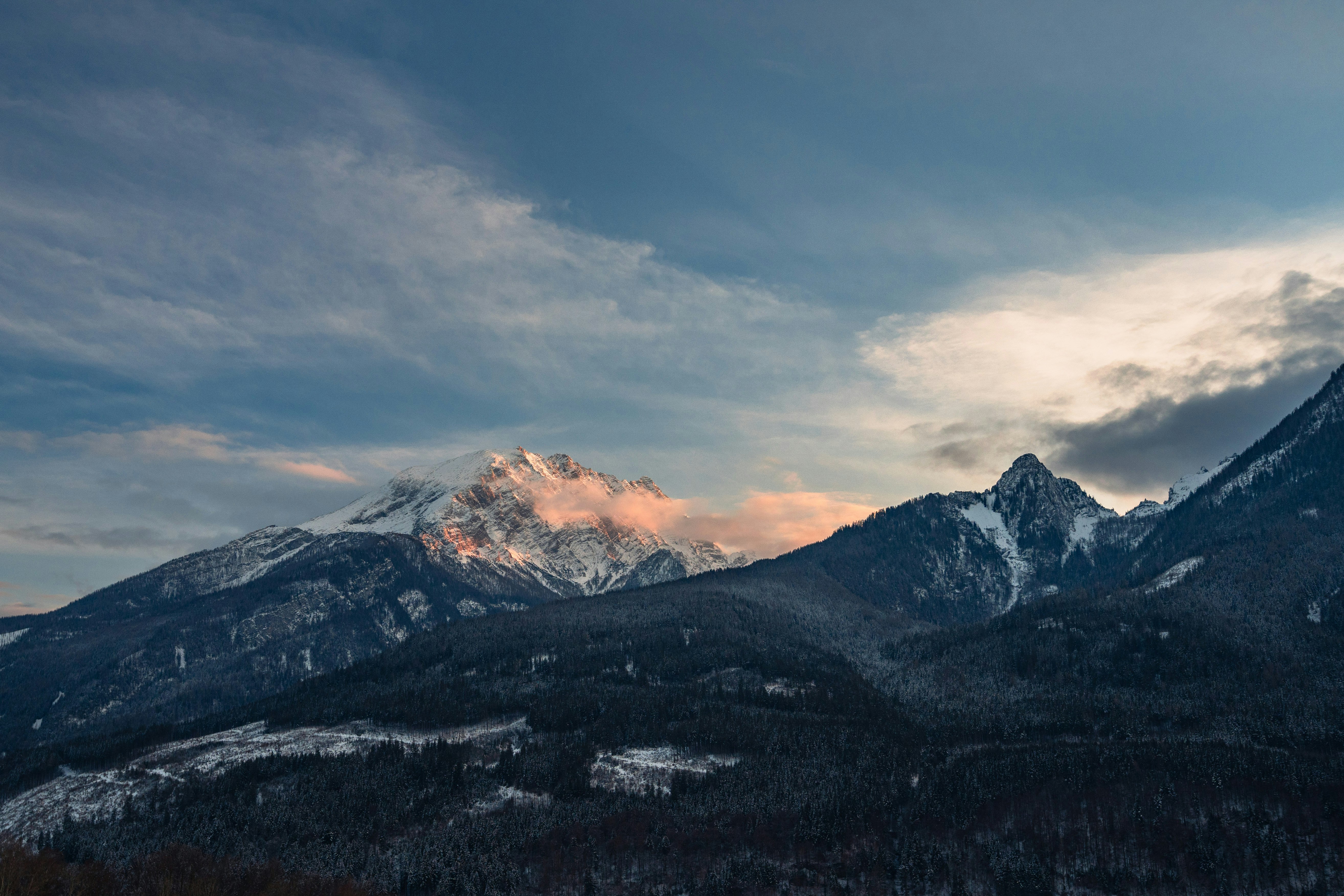 snow covered mountain under cloudy sky during daytime